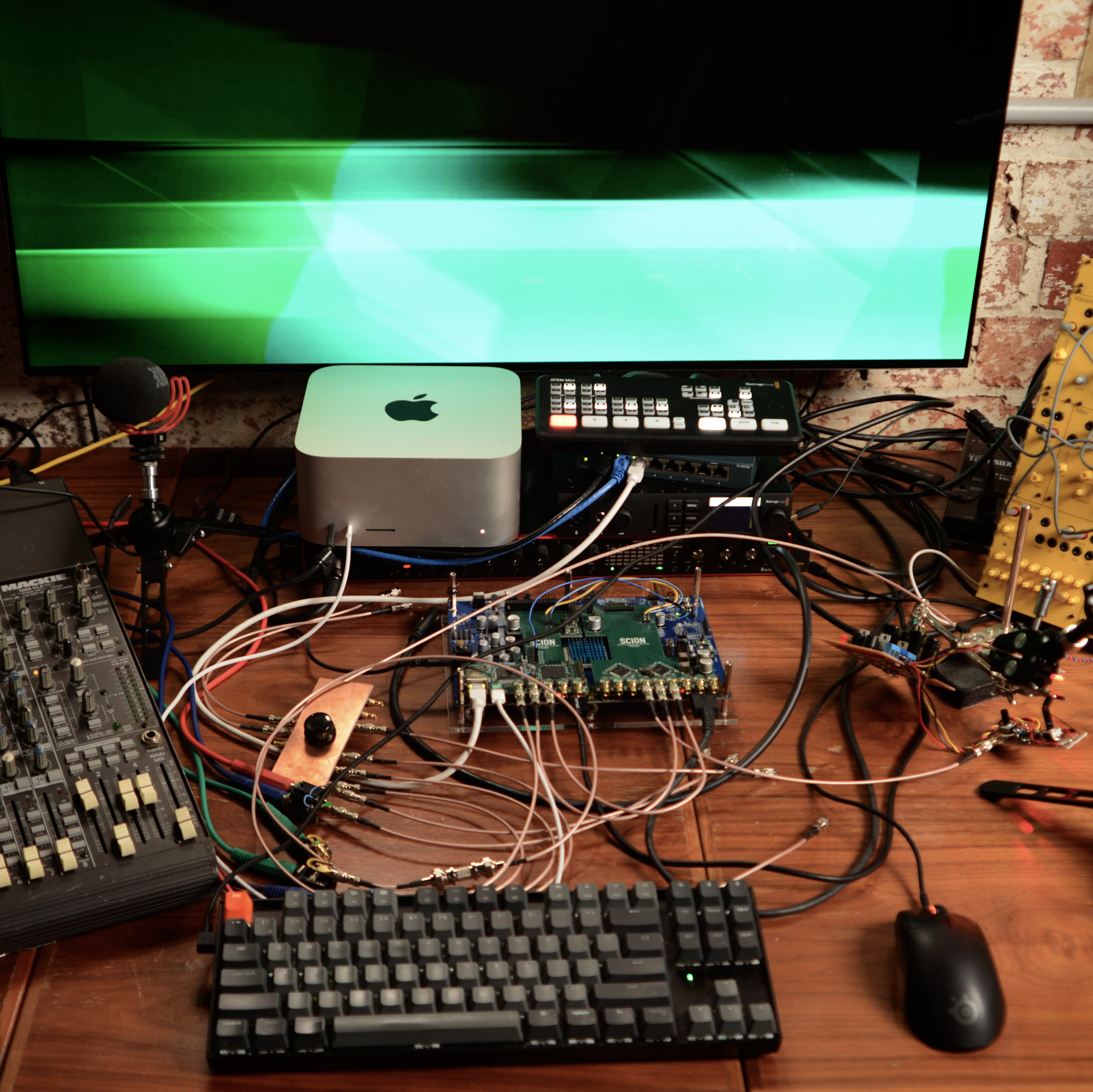 a messy desk with video cables and random electronics